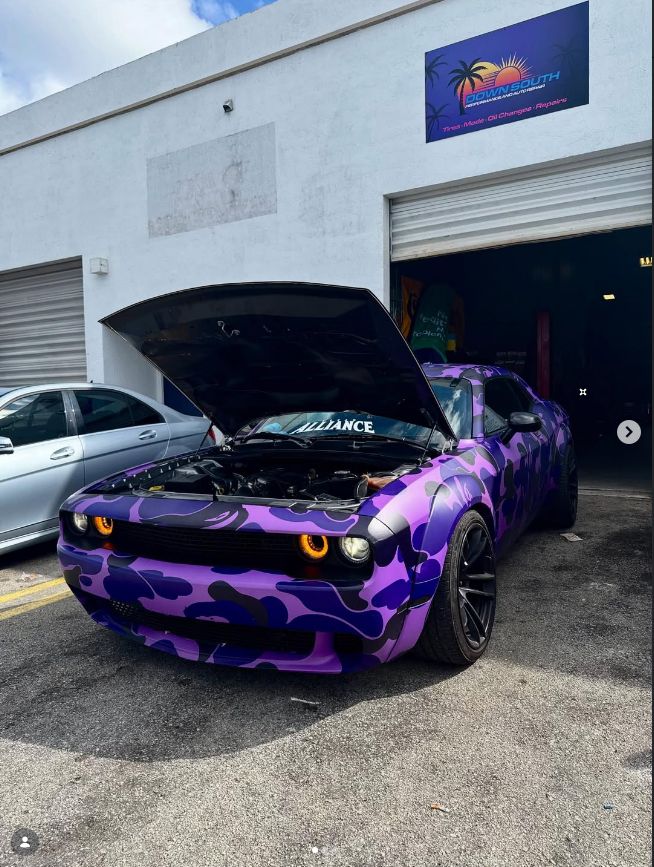 Purple camo-wrapped Dodge Challenger widebody outside the Down South Performance shop